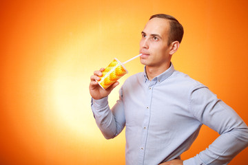 young man drinking a cocktail through a straw