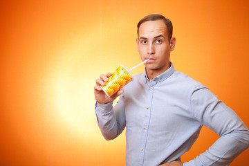 young man drinking a cocktail through a straw