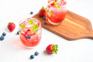 set cocktails strawberry and blueberry mix soda for healty drink but mix whisky for party enjoy