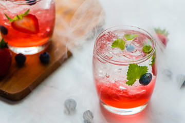 set cocktails strawberry and blueberry mix soda for healty drink but mix whisky for party enjoy