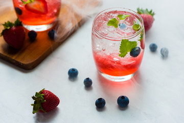 set cocktails strawberry and blueberry mix soda for healty drink but mix whisky for party enjoy