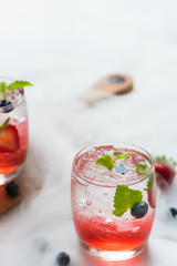 set cocktails strawberry and blueberry mix soda for healty drink but mix whisky for party enjoy