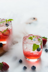 set cocktails strawberry and blueberry mix soda for healty drink but mix whisky for party enjoy