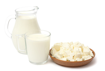 Glass jug pitcher of fresh milk with glass and cottage cheese isolated on white background carafe