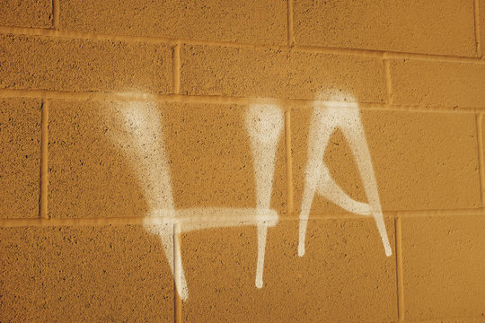 The word "HA" spray painted on exterior of building wall