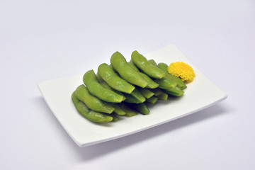 Edamame, or edamame bean in white square plate on white background