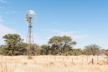 Farm scene with water-pumping windmill on the B1-road