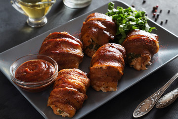 Stuffed chicken breasts rolled in bacon with ketchup