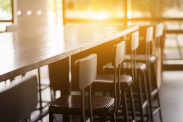Selective focus of table and chair of coffee shop inside view with vintage color tone