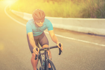 Obraz premium Cycling competition,cyclist athletes riding a race at high speed on mountain road, Sportsmen bikes in the morning,vintage color,selective focus, sports concept,Business competition,copy space
