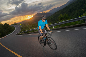 Fototapeta premium Cycling competition,cyclist athletes riding a race at high speed on mountain road, Sportsmen bikes in the morning,vintage color,selective focus, sports concept,Business competition,copy space