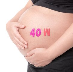 Belly of a pregnant woman with the word " 40 week " isolated on white background