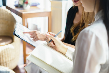 Project managers meeting.Business crew working with new startup,Teamwork concept,Two women discussion document in the office.collaborative filtering.Analyze plans.selective focus,vintage color