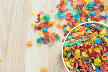 Kids healthy quick breakfast. Colorful rice cereal on wooden background. Copy space