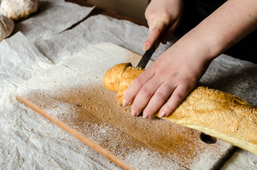 Sliced bread on a wooden board.