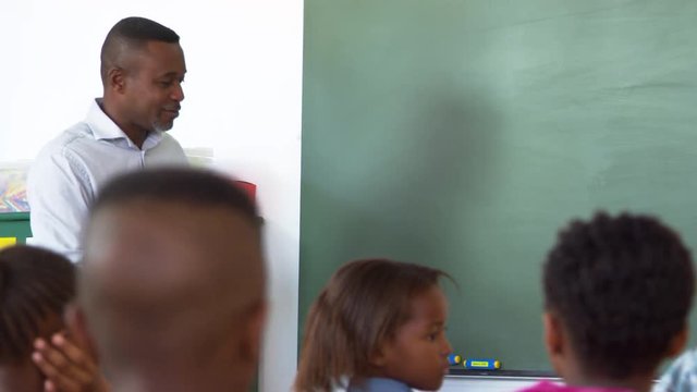 Teacher asks boy to blackboard in elementary school lesson