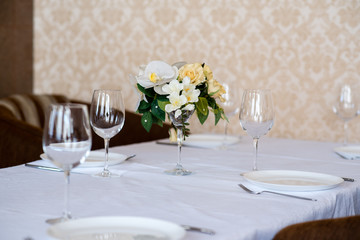 Dining table setting decorated with flowers.
