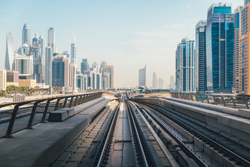 Train tracks and city buildings view in Dubai metro railway network. Dubai, United Arab Emirates