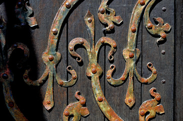 old wood door with metal things and metal door handle