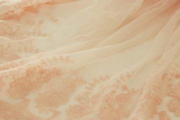 Vintage tulle pink chiffon dress on wooden white table. Wedding and girl's party concept.
