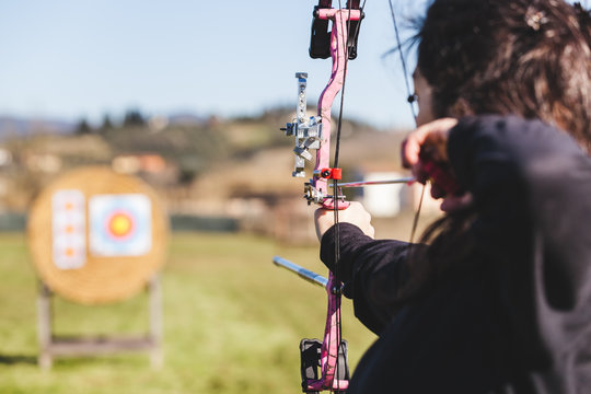 Professional Female Archer Aiming a Target
