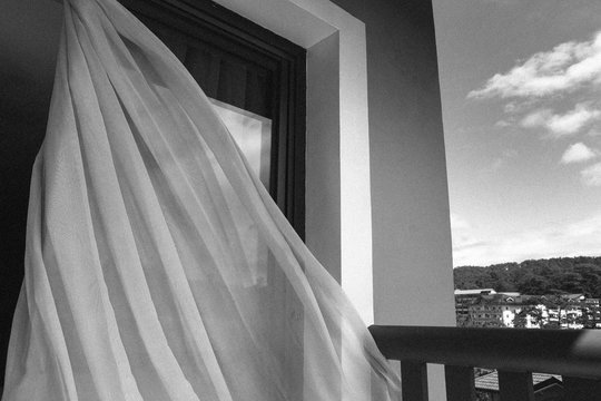 View of a curtain being blown by the wind