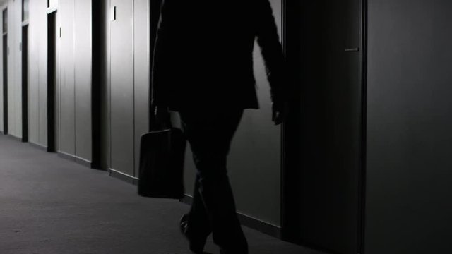 Office employee walking down corridor and turing to the left