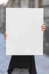 Girl holds a frame for a poster presentation