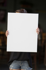 Girl holds a frame for a poster presentation
