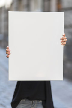 Girl holds a frame for a poster presentation