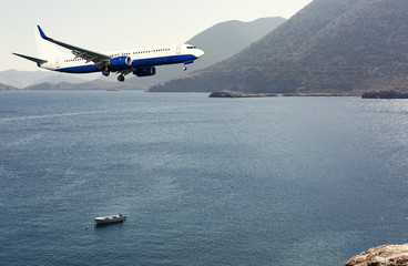 An airplane landing by a sea. Have a nice journey