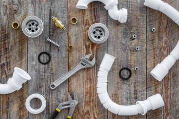 Clear clogged sink drains. Parts and tools on wooden background top view