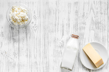 Farm dairy products. Milk, cottage, cheese on light wooden background top view copyspace