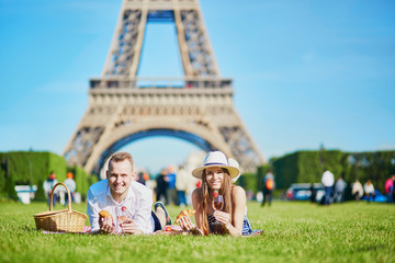 Couple having picnic near the Eiffel tower in Paris, France