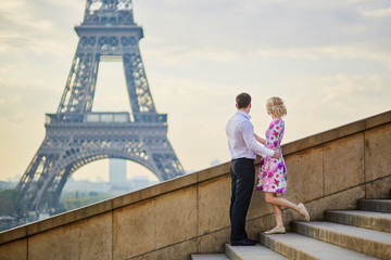 Couple in front of the Eiffel tower in Paris, France
