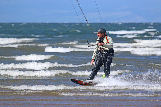kitesurfer riding in waves