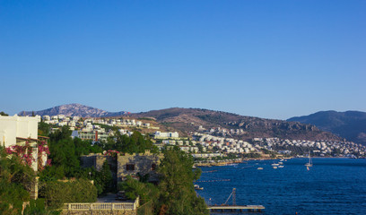 Fototapeta na wymiar View of the Gumbet Bay. Mountainous terrain near the Aegean Sea. Typical buildings on the mountain near the sea. Bodrum. Turkey.