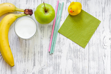 Kids breakfast with fruits on light wooden table background top view copyspace