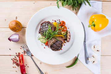  Beef steak on a wooden background on top