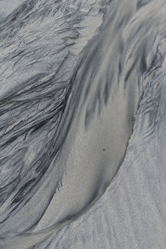 Patterns and textures in wet sand formed by receding tide
