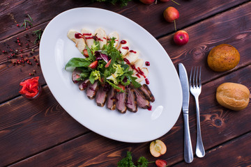  Meat plate on a wooden background