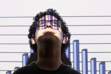 Teenage boy standing against interactive whiteboard in school