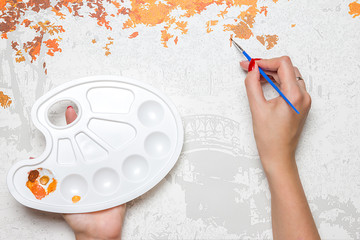 The concept of a hobby. Hand of a young girl draw with a brush painting by numbers on canvas