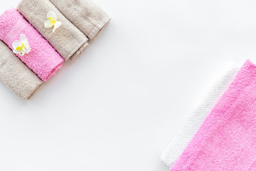 Preparing for spa. Fresh towels on white background top view copyspace