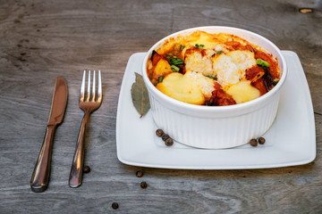 Fresh tomato cake with cheese on a gray wooden background