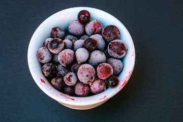Frozen berries on a black background. Close Up