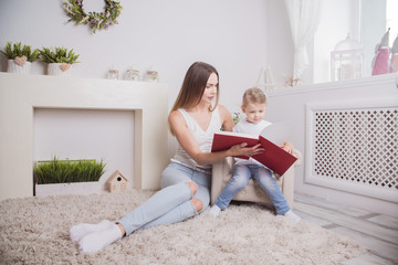 happy mother and child together read the book
