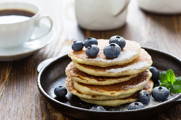Blueberry buttermilk pancakes on rustic table