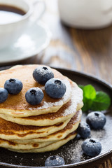 Blueberry buttermilk pancakes on rustic table