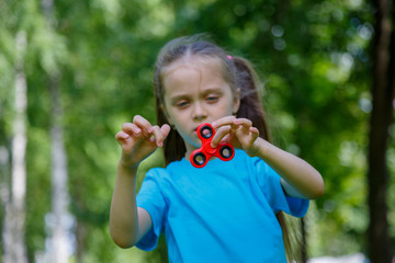 Little girl playing with fidget spinner
